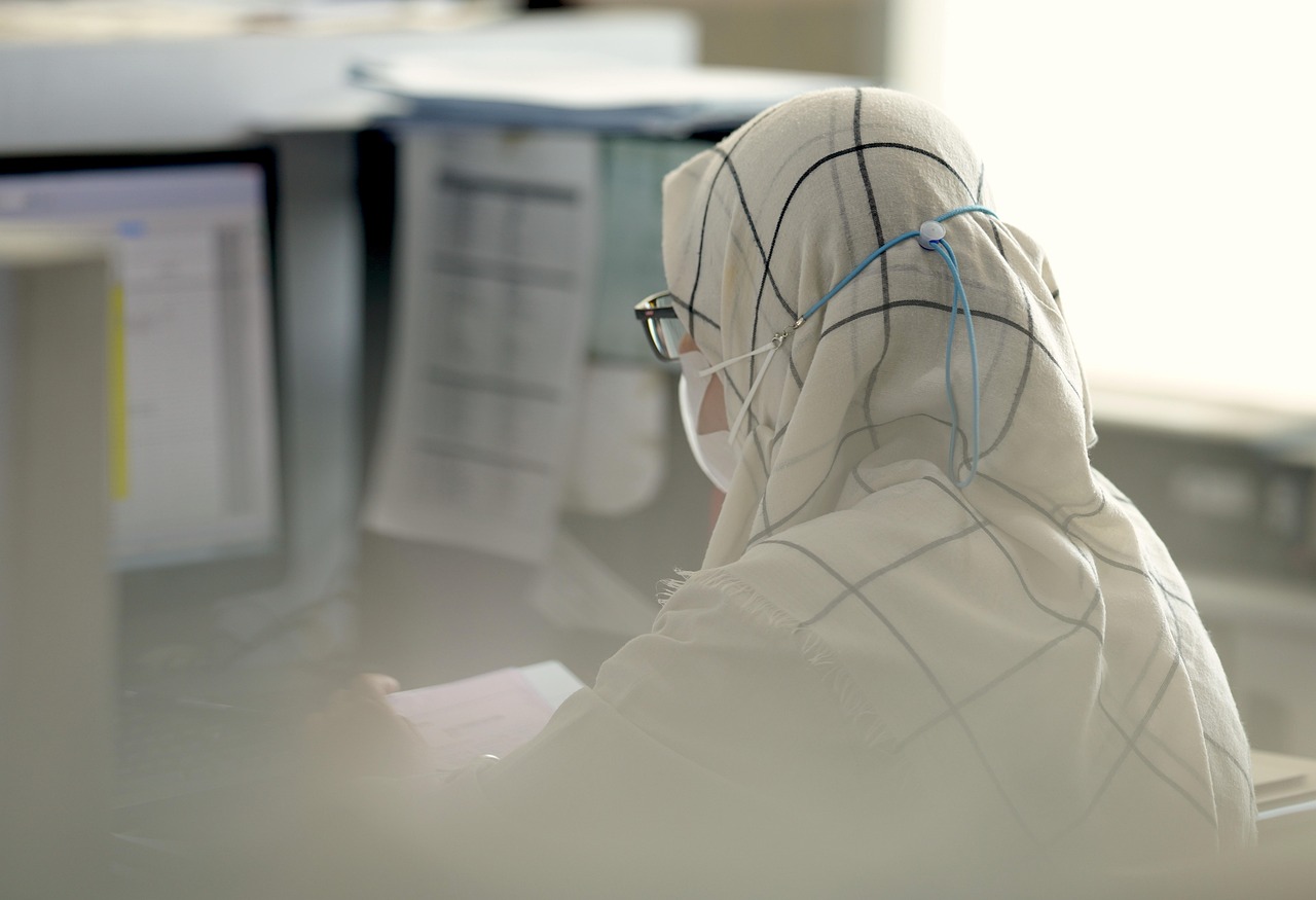 Woman, administrator, computer — Aligned for Wellness: Finding a Chiropractor in Dubai for Whole-body Health