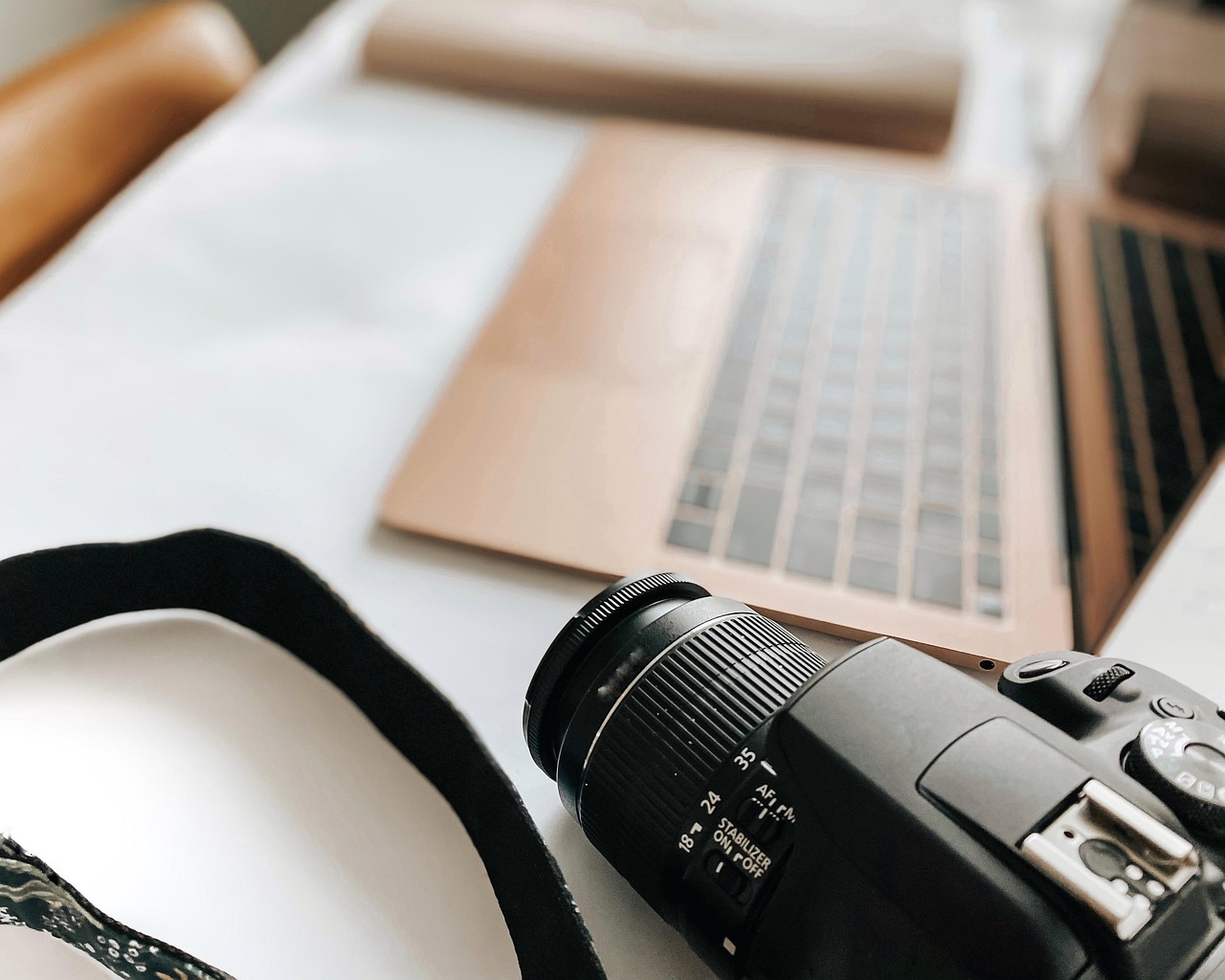 Laptop, camera, desk — Professional Rejuvenation: Business Trip Massage