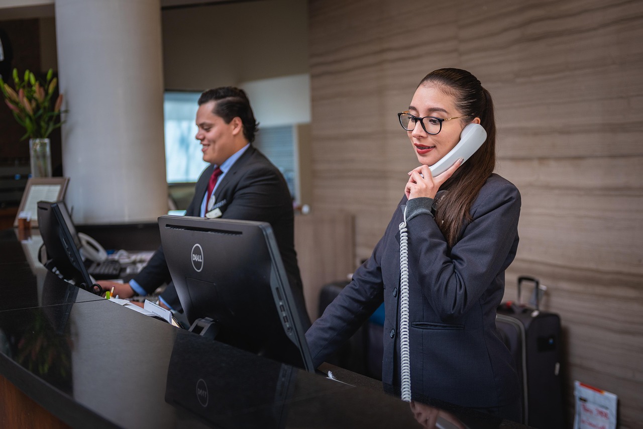 Receptionists, phone call, hotel — Sensual Delights: Elevate Your Bedroom Experience with Adult Essentials