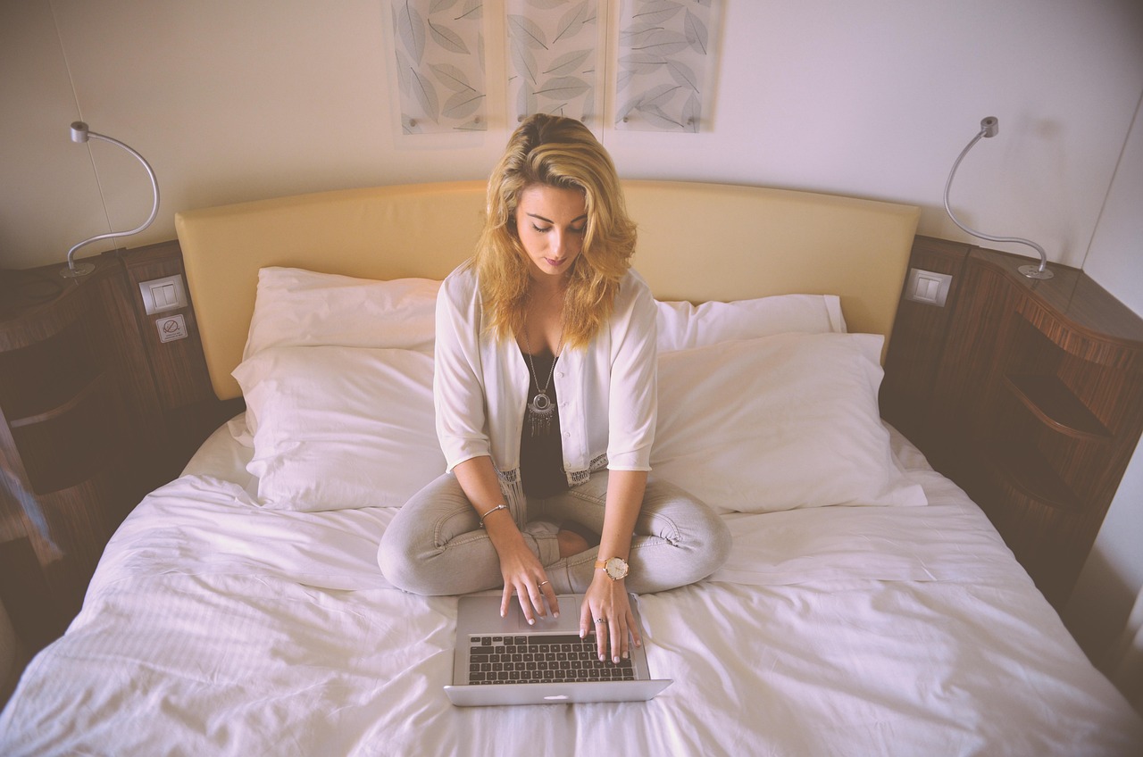 Woman, working, bed — Training Your Dog with a Halo Collar